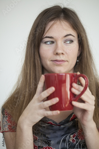 Young Woman with Beautiful Green Eyes with Red Coffee Cup