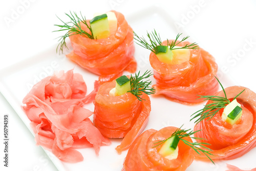rolls with salmon and pickled ginger on a white background