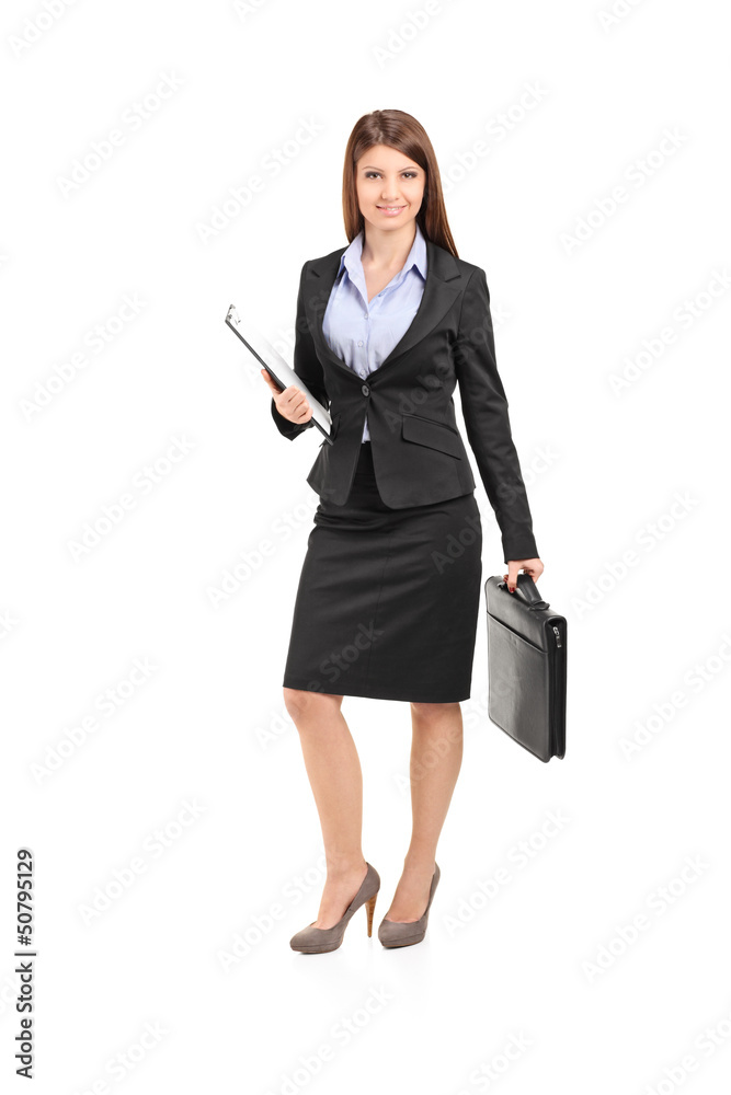 Full length portrait of a businesswoman with clipboard holding a Full length portrait of a businesswoman with clipboard holding a