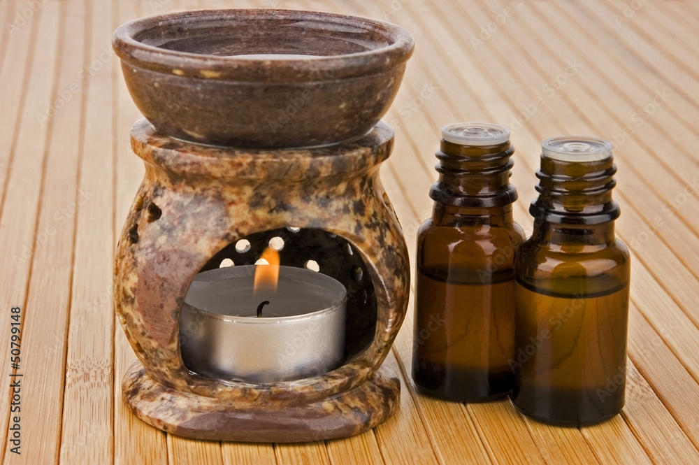 Aromatherapy lamp and oils on bamboo