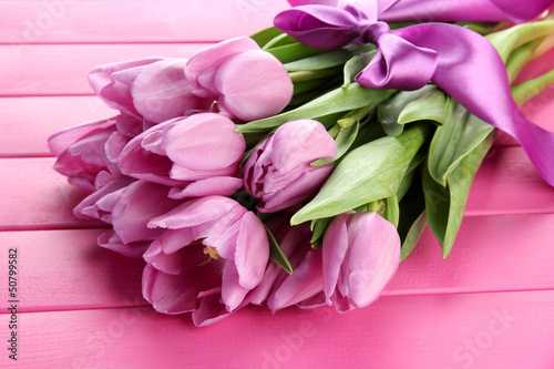 Fototapeta Naklejka Na Ścianę i Meble -  Beautiful bouquet of purple tulips on pink wooden background