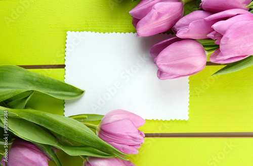 Fototapeta Naklejka Na Ścianę i Meble -  Beautiful bouquet of purple tulips and blank card