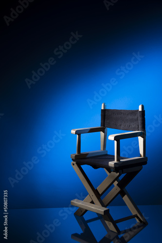 Director chair on a dramatic lit background