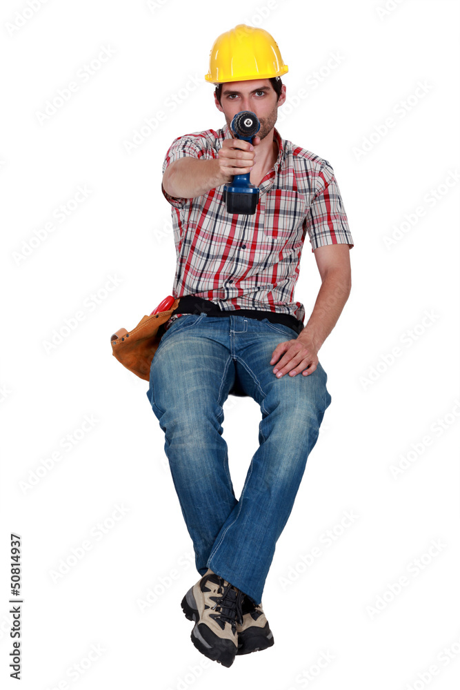Laborer holding a drill Laborer holding a drill