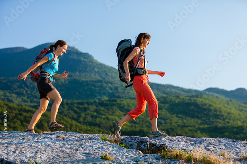 Two women is trekking in the Crimea mountains with backpacks