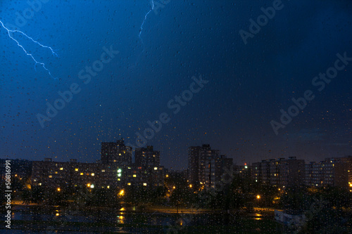 danger flash on panel building in night with drops on window photo