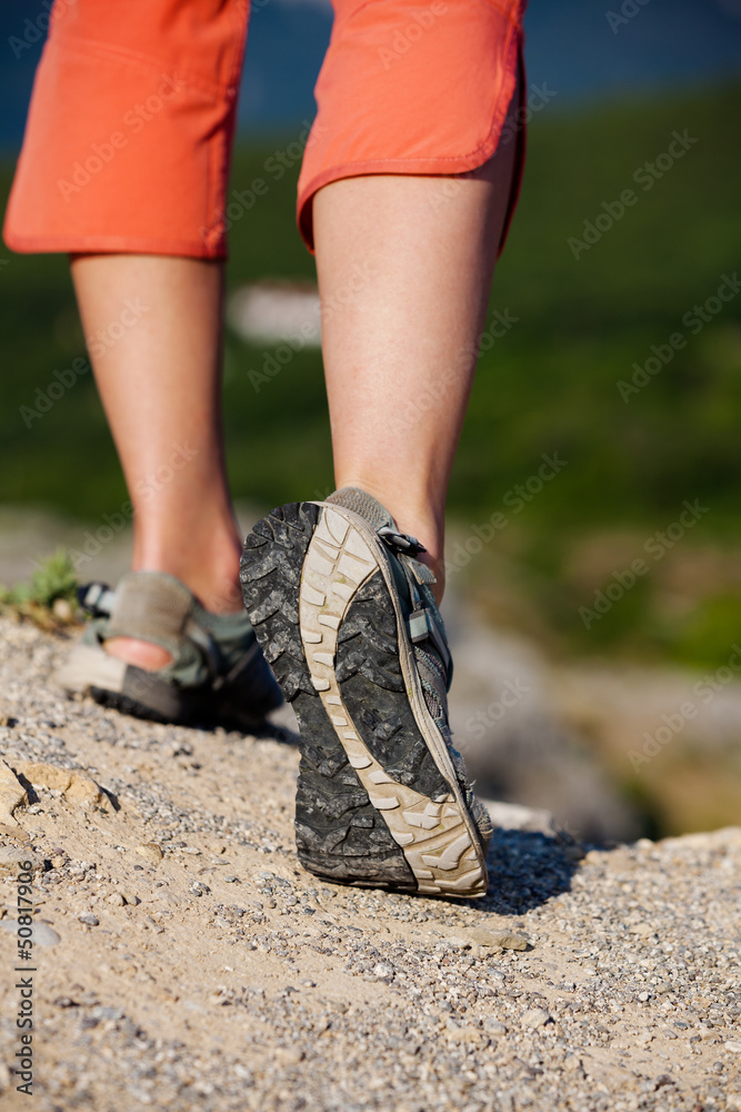 Trekker makes her way in sandals loseup Trekker makes her way in sandals loseup