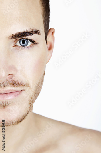 Portrait of a sportive young man isolated on white half face