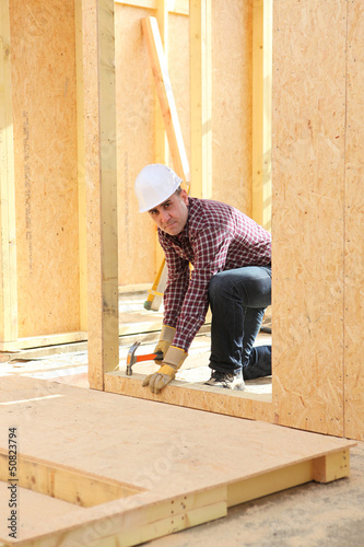 Builder constructing a house