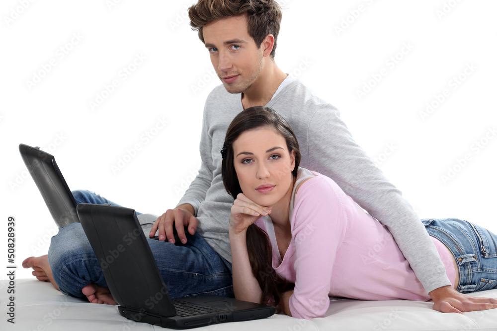 Couple relaxing with their laptops Couple relaxing with their laptops