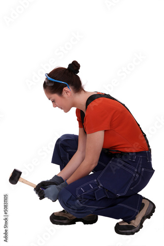 Woman kneeling with mallet © auremar