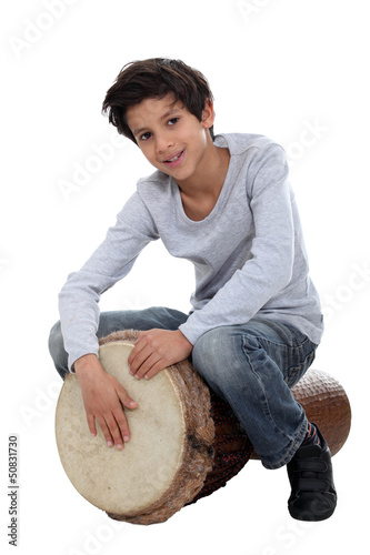 Картината върху платно Young boy playing the djembe