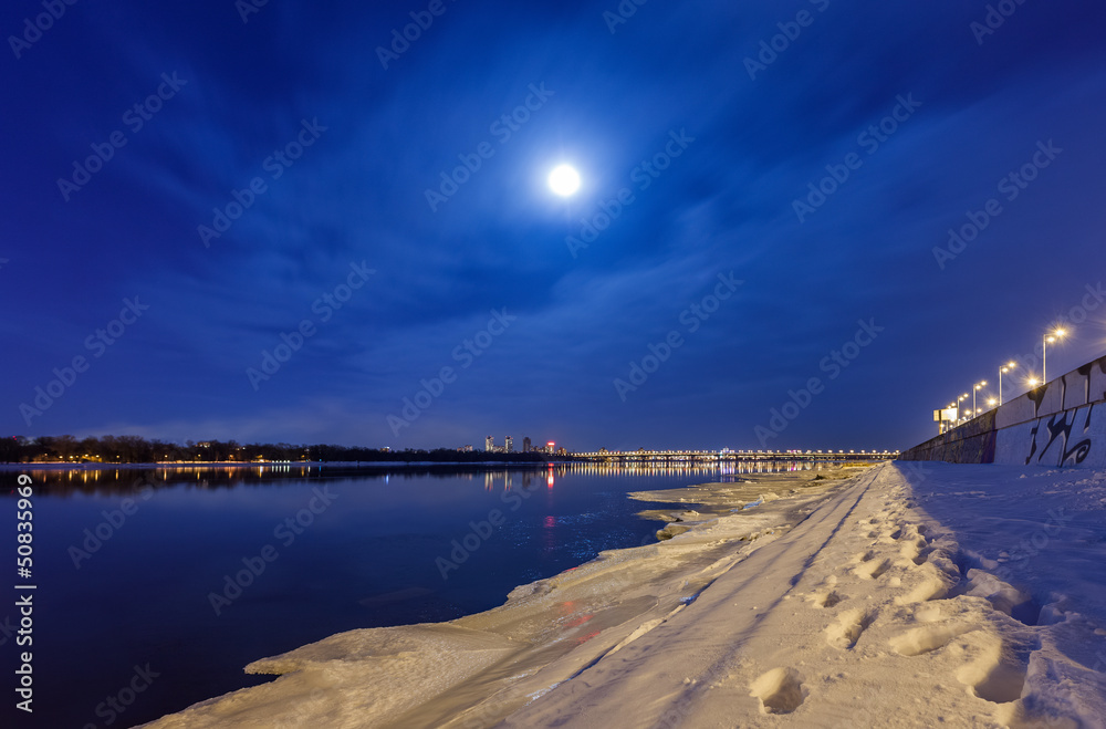 Night cityscape with river and moon