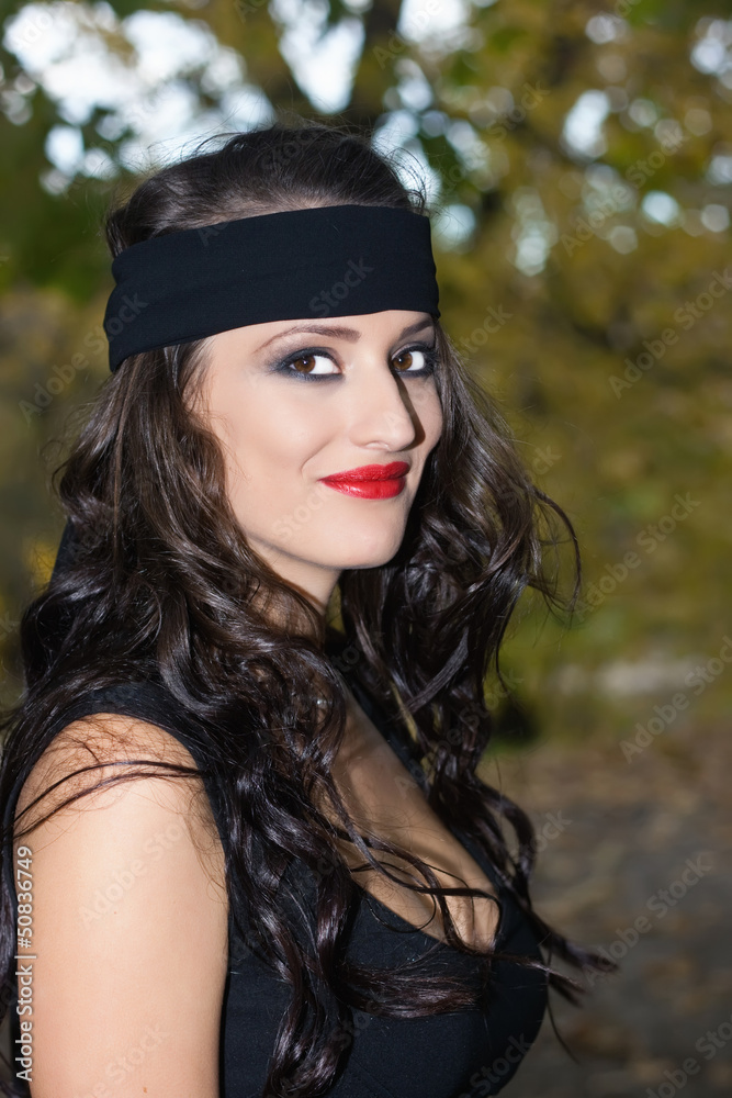 Fototapeta premium Beautiful brunette with a black headband