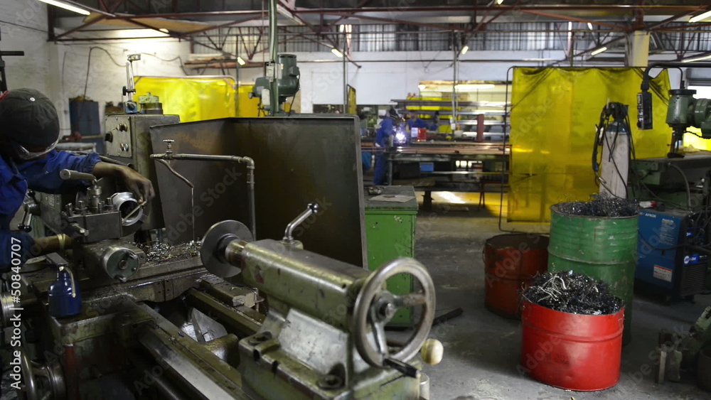 An industrial service repairmen labouring in workshop, selective