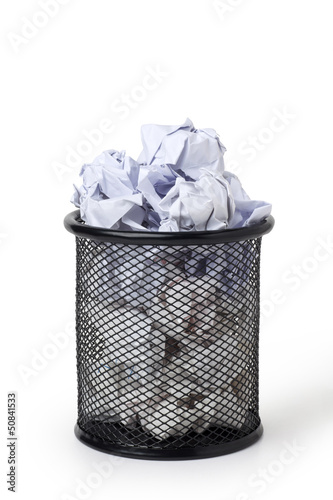 Wastepaper basket full of crumpled paper