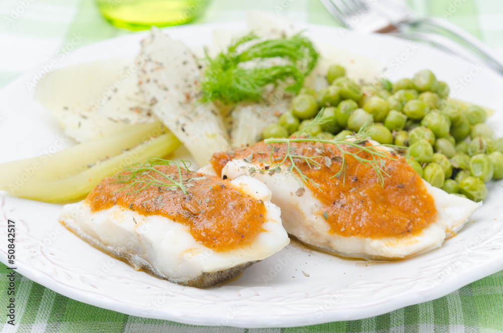Fish with tomato sauce and vegetables closeup Fish with tomato sauce and vegetables closeup