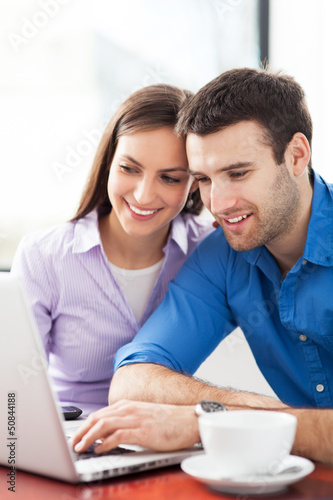 Young couple using laptop © pikselstock