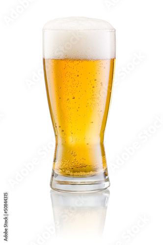 Glass of fresh beer with cap of foam isolated on white backgroun