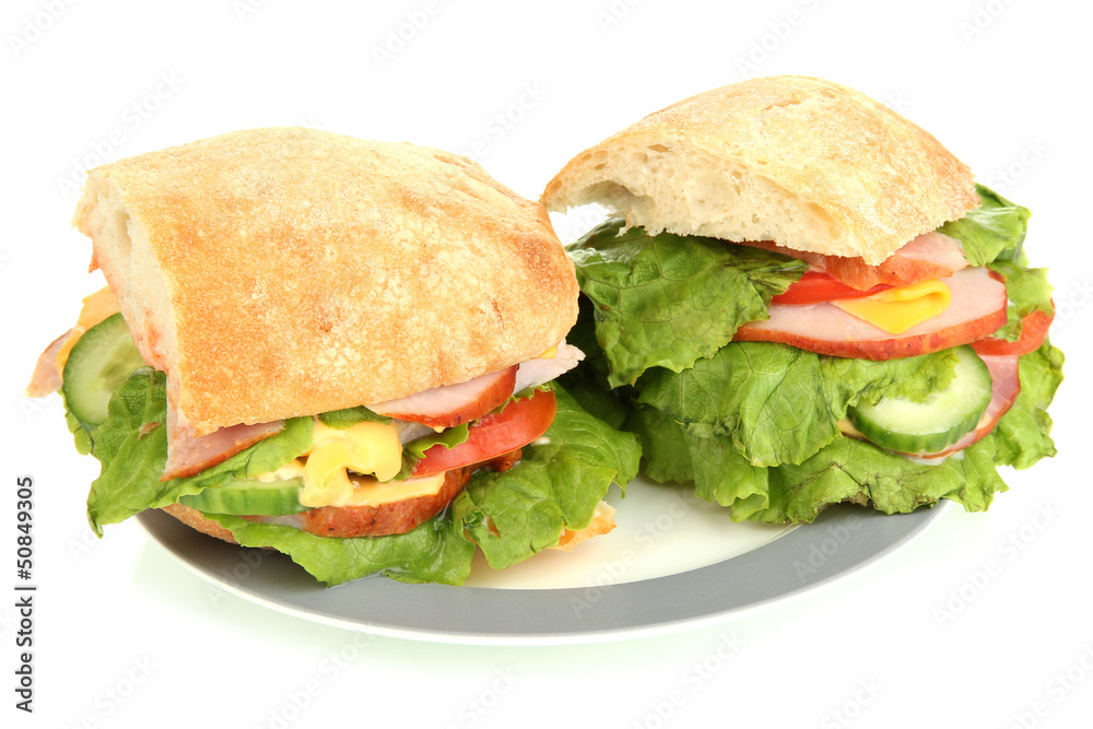 Sliced sandwich with ham and vegetables isolated on white