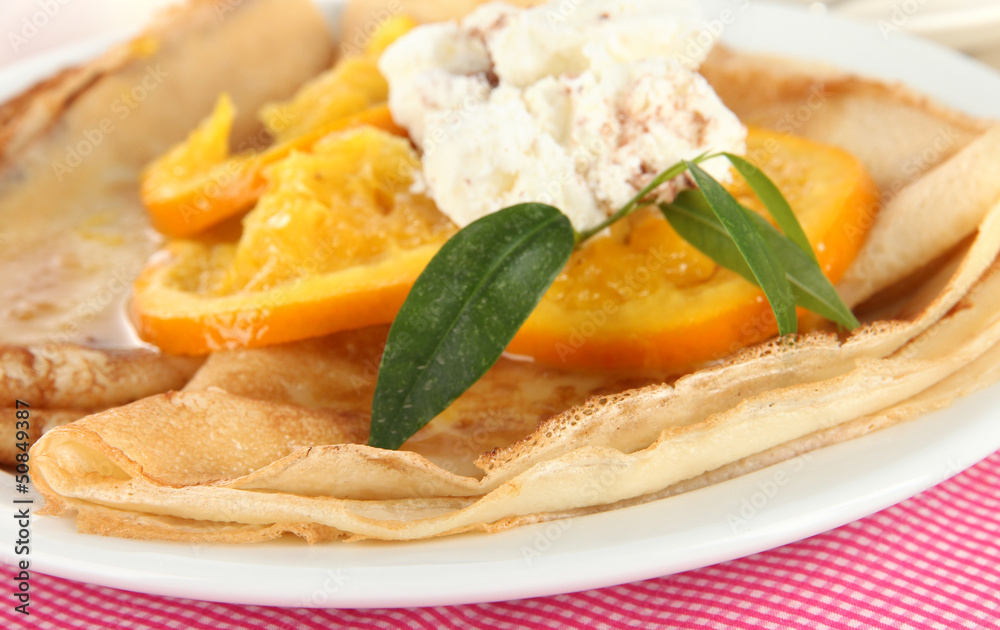 Pancakes with orange on napkin close-up Pancakes with orange on napkin close-up