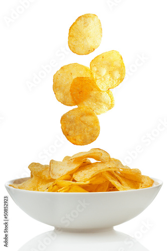 Potato chips falling in a bowl photo