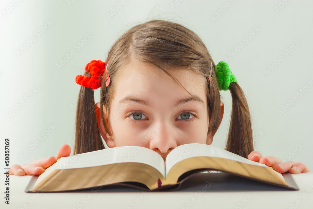 Surprised teen girl with the Bible