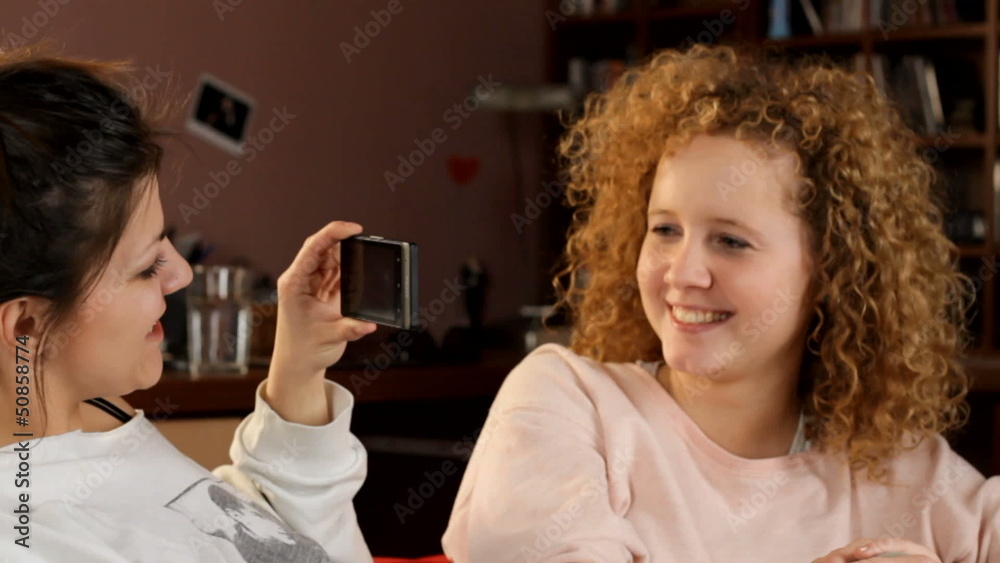 Young friends taking a picture by phone - tracking shot Young friends taking a picture by phone - tracking shot