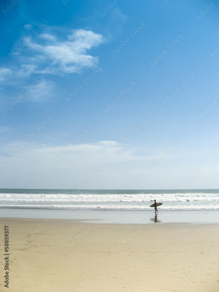 surfer on kuta beach bali indonesia
