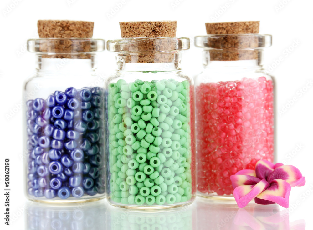 Little bottles full with colorful beads isolated on white Little bottles full with colorful beads isolated on white