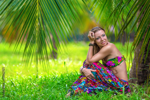 beautiful girl under a palm tree