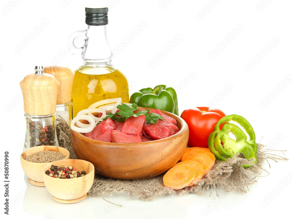 Raw beef meat in bowl with herbs, spices and cooking oil