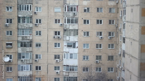 Snow falling over buildings constructed during the communist era