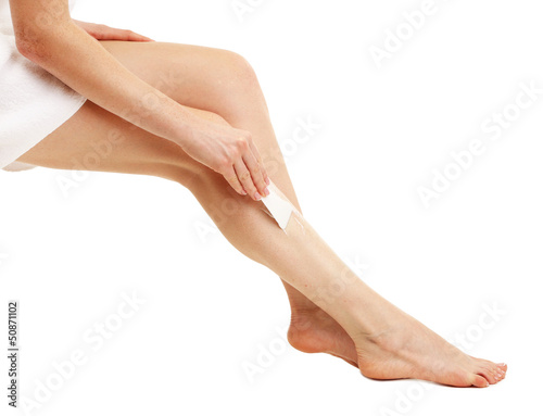 Beautiful woman legs with depilation cream, isolated on white