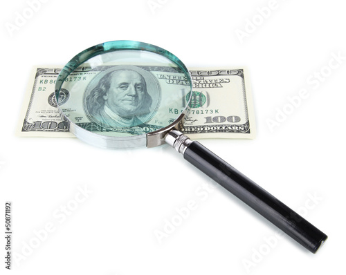 Hundred dollar bill and magnifying glass isolated on white