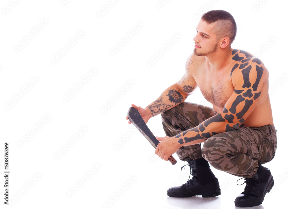 Russian man with machete is sitting and leaning on his feets Russian man with machete is sitting and leaning on his feets