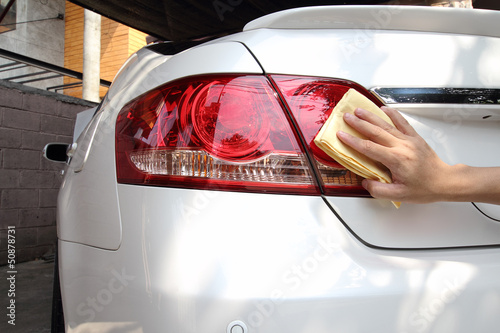 Hand with a wipe the car polishing