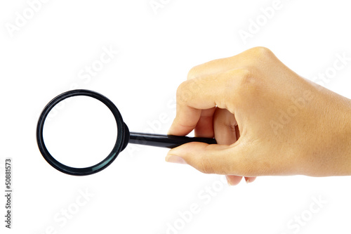 Hand holding magnifying glass on white backckground