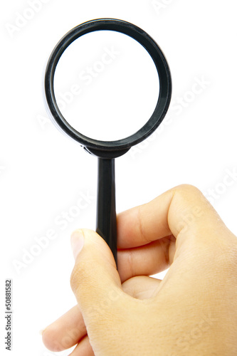 Hand holding magnifying glass photo