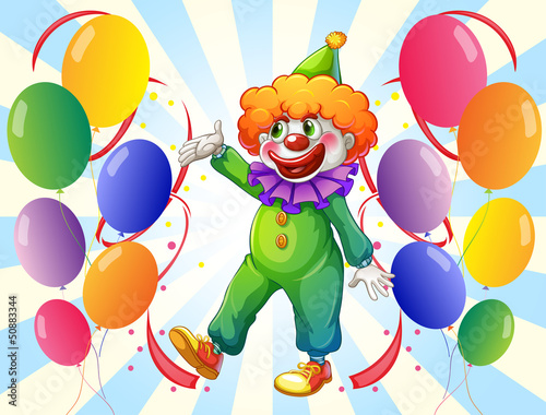 A male clown in the middle of the balloons