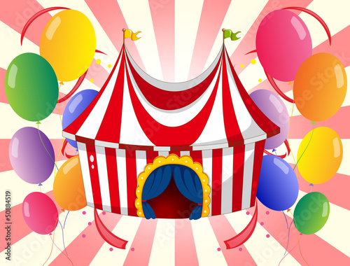 A red circus tent with colorful balloons