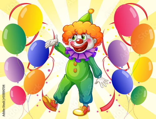 A clown in the middle of the balloons