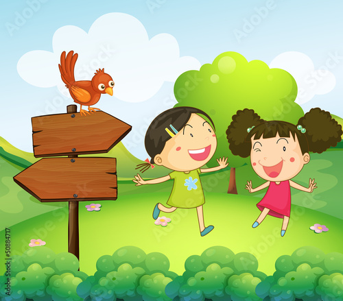 Two girls playing beside the two arrow boards