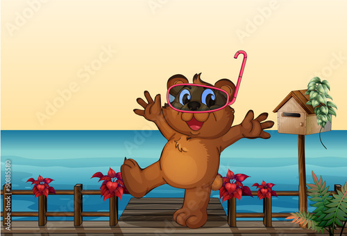 A young bear at the wooden bridge