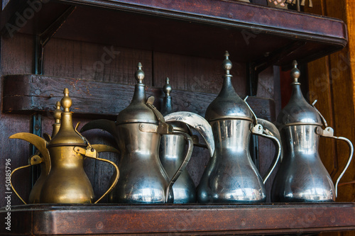 Eastern pitchers stand on a shelf photo