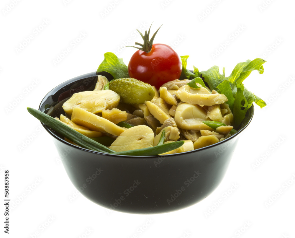 Marinated mushrooms in white saucer isolated on white Marinated mushrooms in white saucer isolated on white