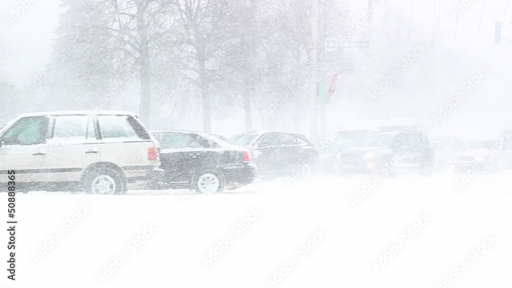 Busy traffic on country road at night in heavy snowstorm