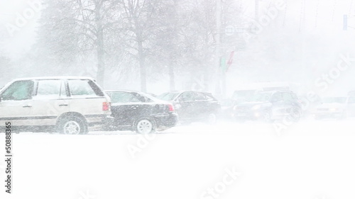 Busy traffic on country road at night in heavy snowstorm
