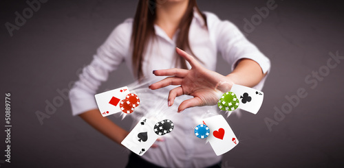 Young woman playing with poker cards and chips
