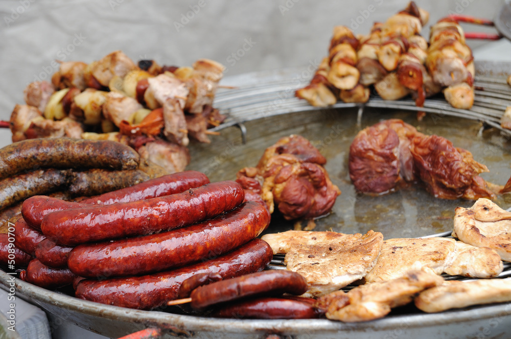 grilled sausages, meats and kebabs on a plate